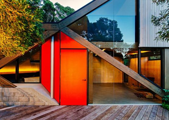 a red door and glass wall of a house