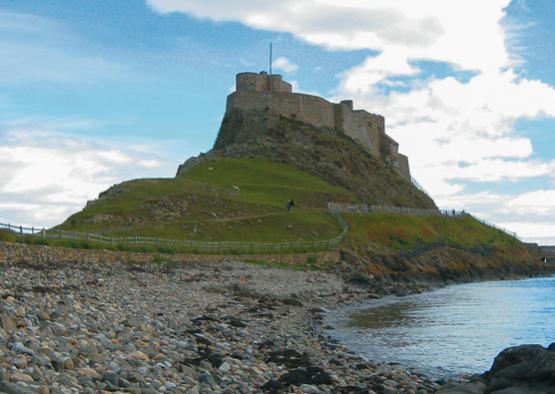 a castle on a hill by the water