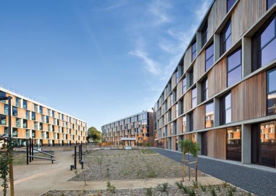 a building with a garden and a walkway