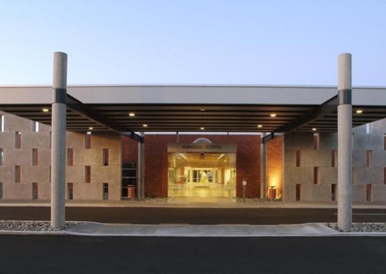 a hospital entrance with a covered entrance