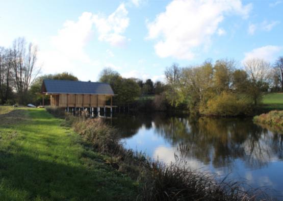 a building on a dock by a lake