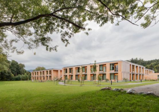 a building with many windows and grass