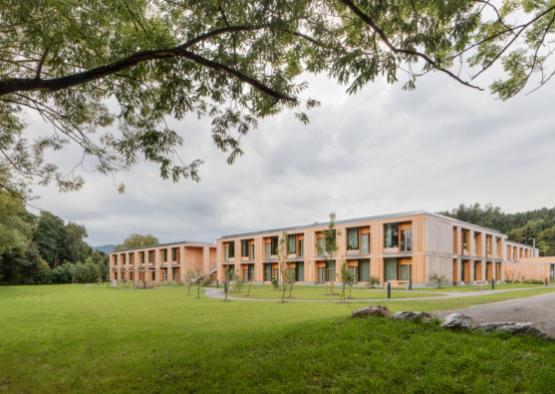 a building with many windows and grass