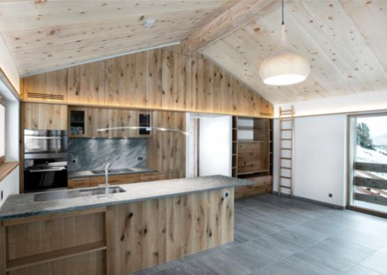 a kitchen with wood paneling