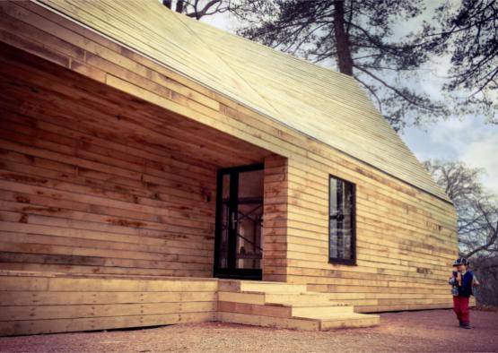 a wooden house with a door and steps