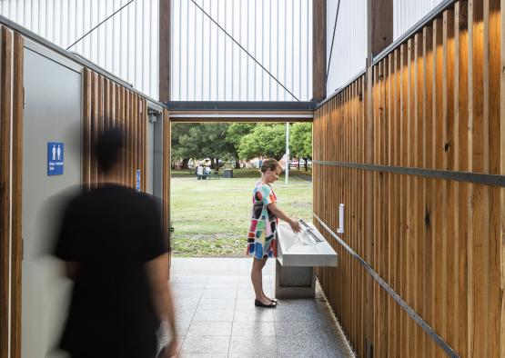 a woman standing in a public restroom