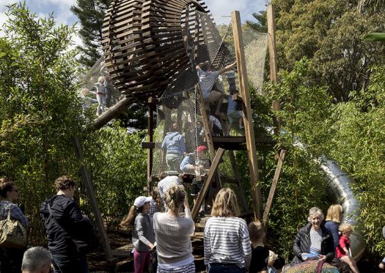 a group of people standing around a wooden structure