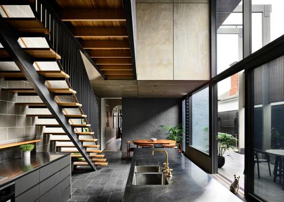 a kitchen with a staircase and a sink