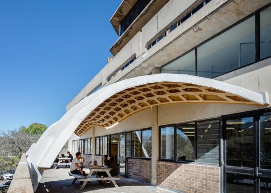 people sitting on a bench under a canopy