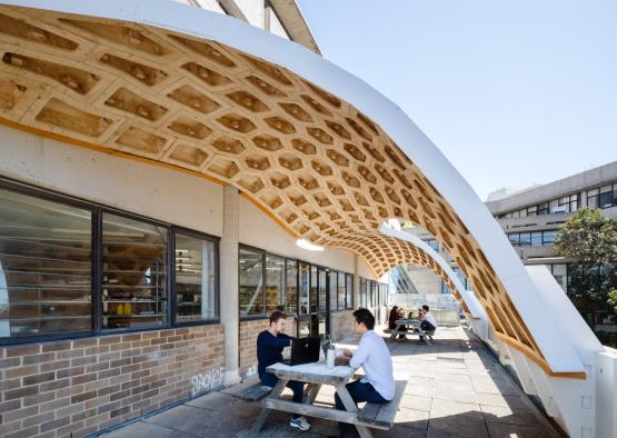 people sitting at a table under a roof