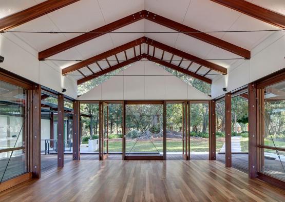 a room with glass doors and wood floors