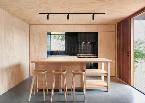 a kitchen with a table and stools