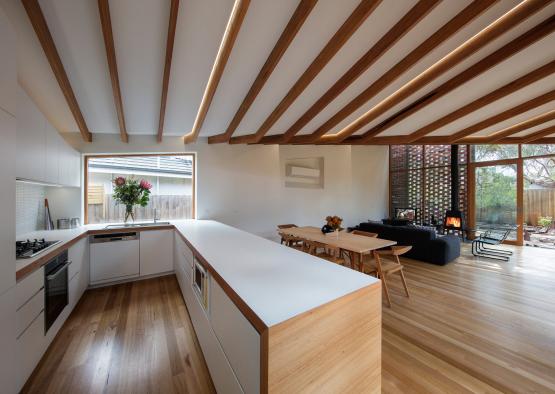 a room with a kitchen and dining table