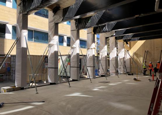 a building under construction with several poles