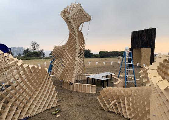 a wooden structure outside with a ladder and a table