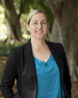 Headshot of woman standing in front of trees