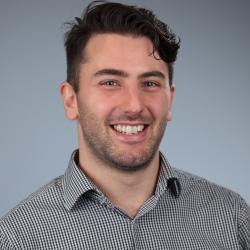 Headshot of man against grey backdrop