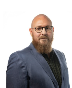 Man with glasses and beard standing against white background