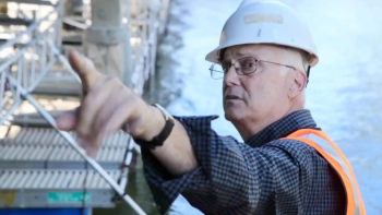 a man in a hard hat pointing at something