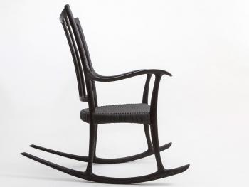 a black rocking chair with a white background