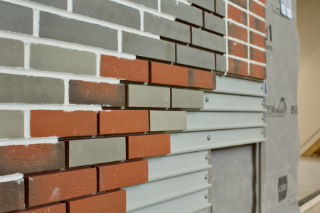 a brick wall with a white wall and gray wall