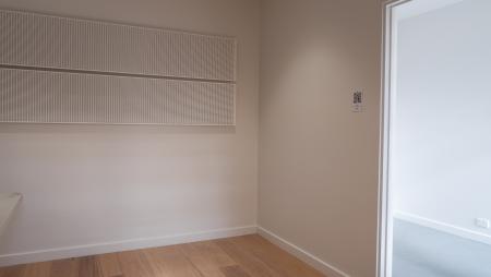 a room with a white wall and a wooden floor