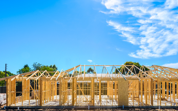 a building under construction with a roof frame