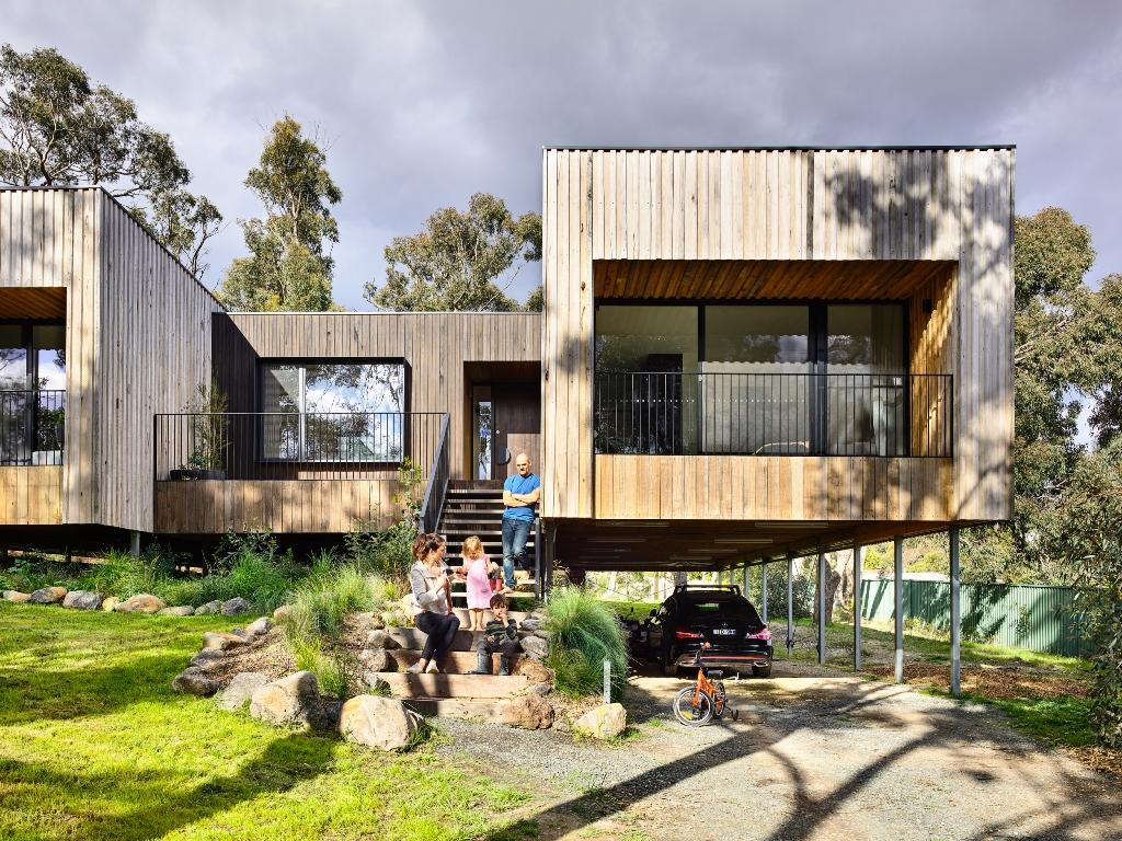 a family standing on stairs in front of a house