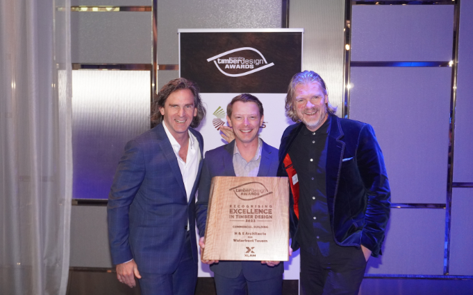 a group of men holding a plaque