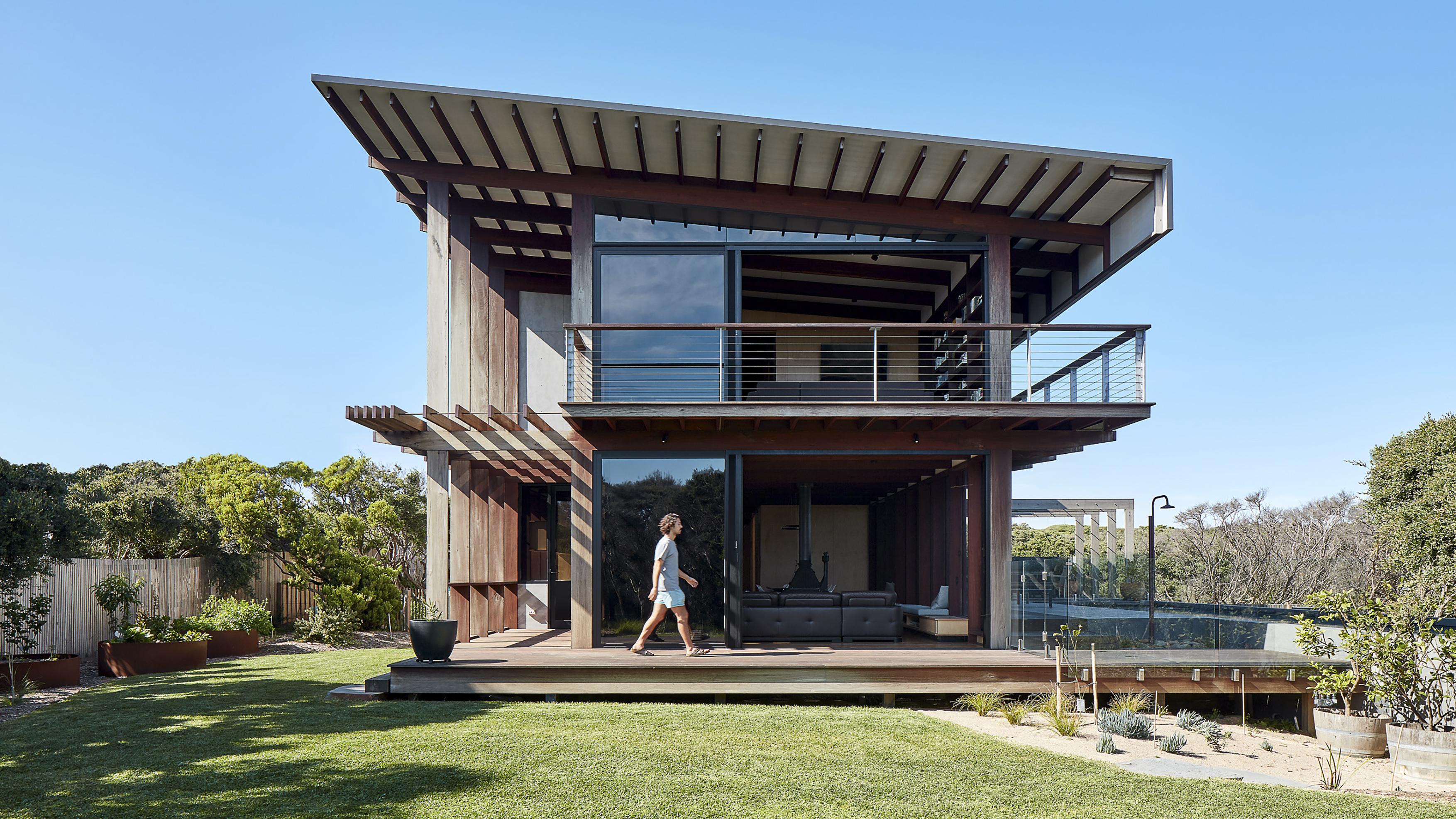 a person walking in front of a house