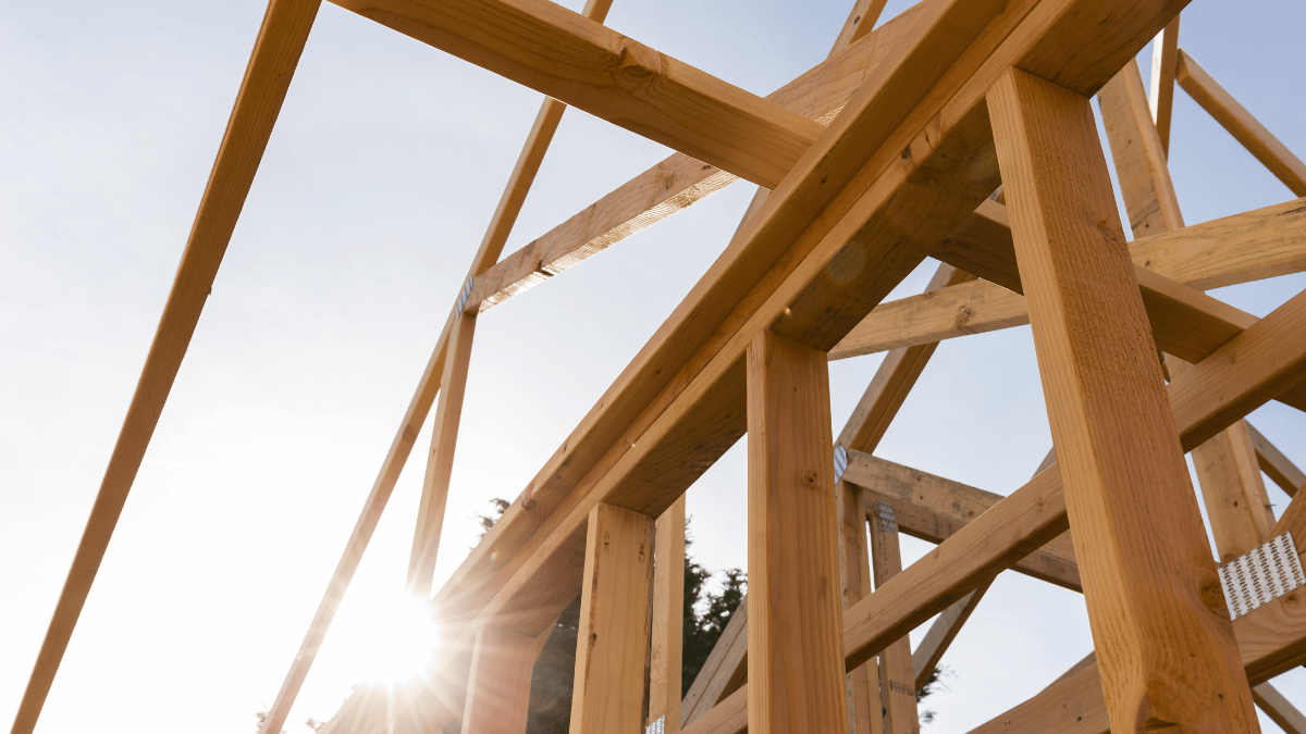 Sun shining through timber house frame