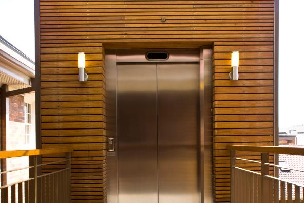 a metal elevator door with two lights