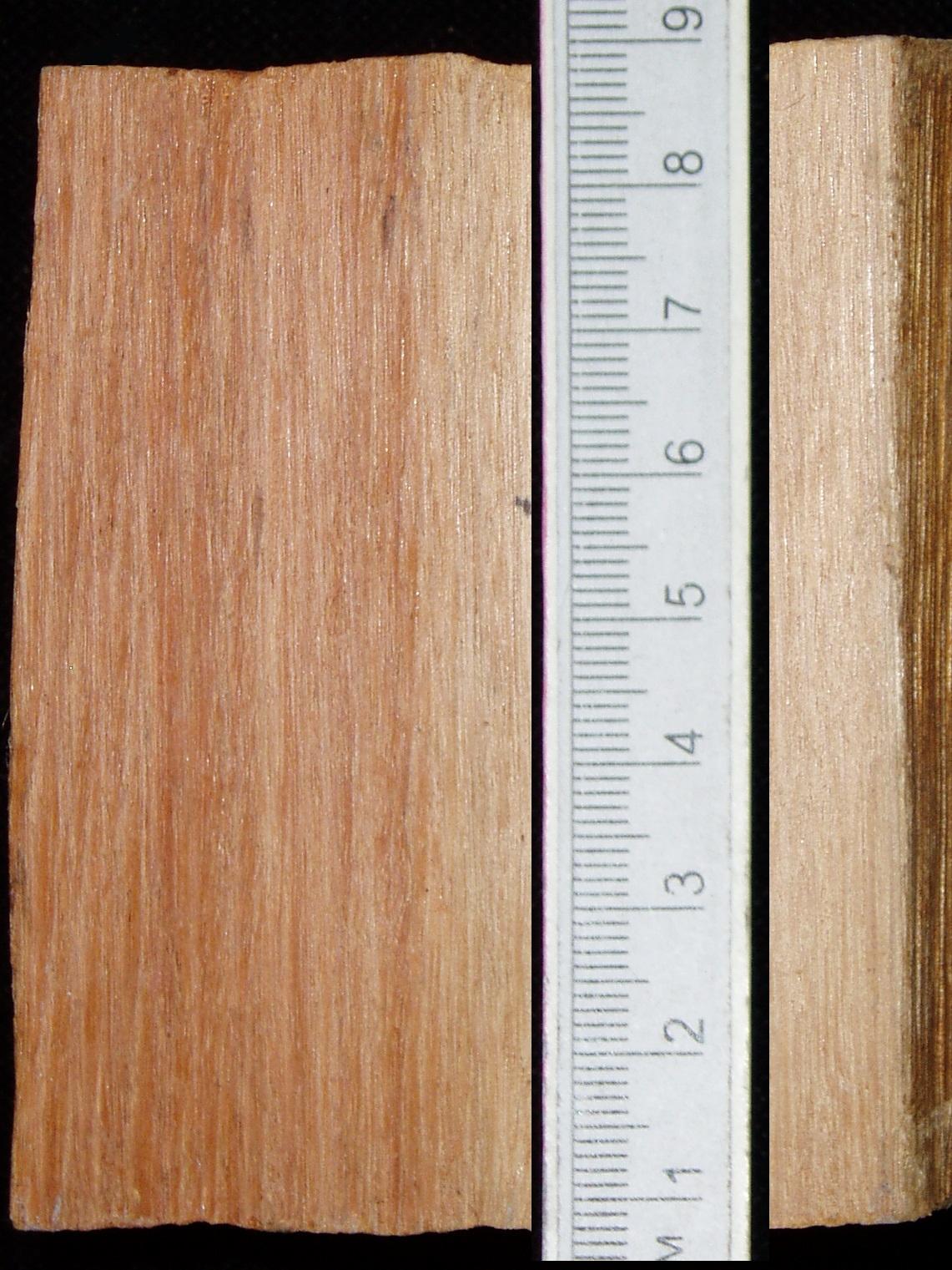 a white ruler on a wood surface