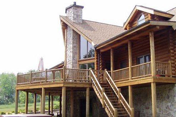 a log cabin with a large porch