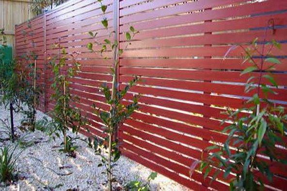 a red fence with small plants