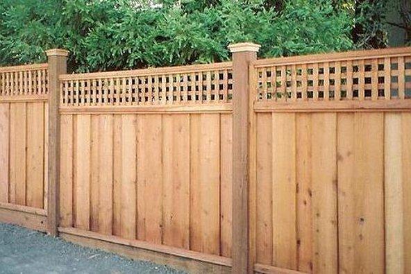a wooden fence with a lattice top