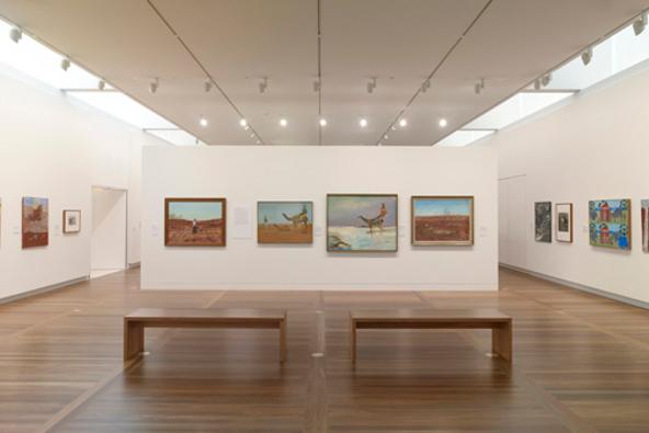 a room with benches and paintings on the wall