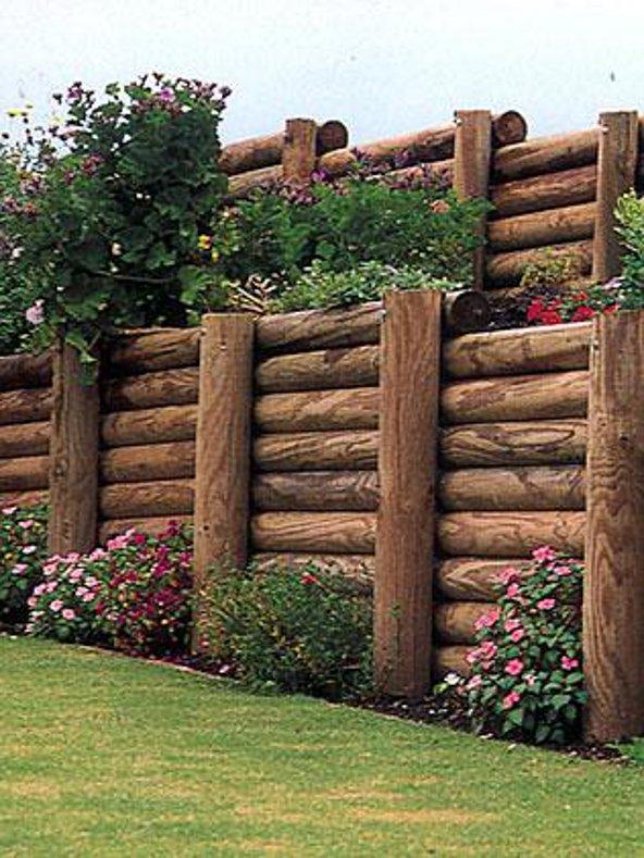 a wooden fence with flowers and plants