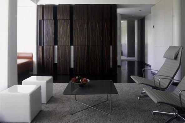 a room with a black table and chairs