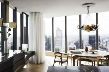 a room with a table and chairs and a chandelier