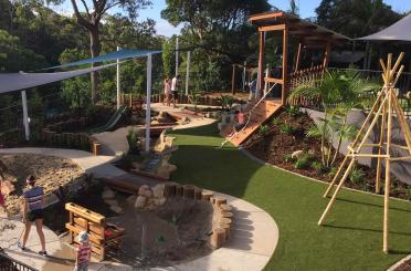 a playground with a slide and a sand pit