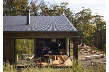 a building with a glass wall and a chair in the middle of it