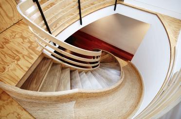 a spiral staircase with wooden railings