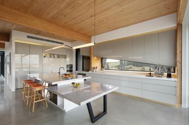 a kitchen with a large island and stools