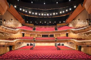 a large auditorium with red seats