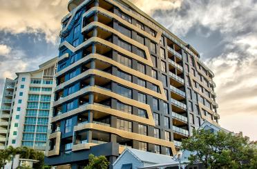 a tall building with many balconies