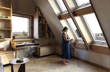 a woman standing in a room with a window