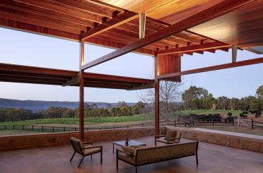 a patio with a couch and chairs