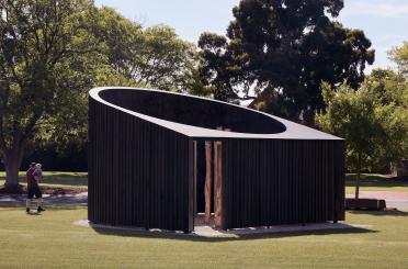 a wooden structure in a grassy area