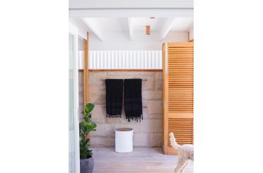 a towel rack with black towels on a brick wall